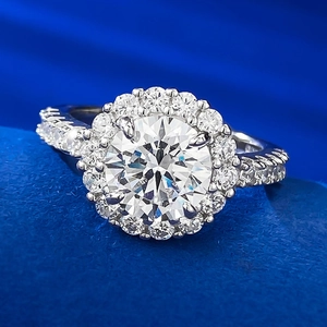 Classic 8mm round brilliant halo diamond ring with sparkling side stones on blue velvet