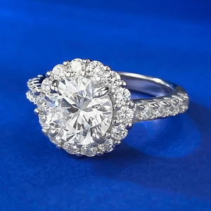 Classic halo engagement ring featuring an 8mm round simulated diamond in white gold finish