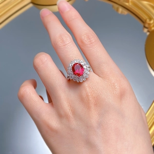 Close-up of elegant S925 silver cluster ring with oval red gemstone and halo diamonds
