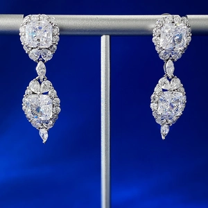 Macro detail of 925 silver earrings with square-cut yellow diamond and marquise accents