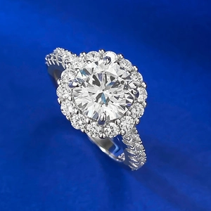 Macro side view of a round halo engagement ring with silver band and sparkling white gems