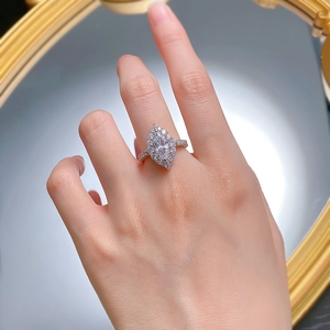 Elegant marquise cut halo diamond ring in silver finish worn on finger for jewelry display