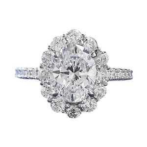 Elegant 7x9mm oval halo diamond ring in polished silver setting with pave band detail
