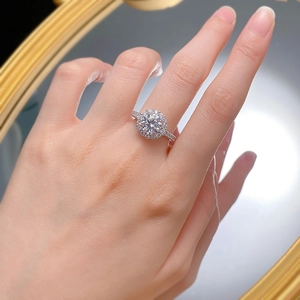 Classic halo engagement ring with a round brilliant cut diamond on a pavé band