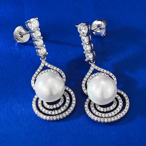 Detailed macro view of S925 sterling silver gourd earrings with 10mm pearl drop