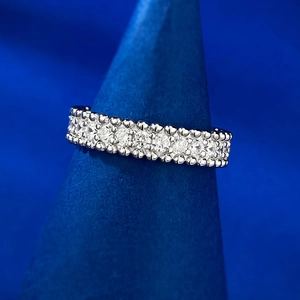 Close-up of a 925 sterling silver eternity band with pave diamonds on a velvet stand
