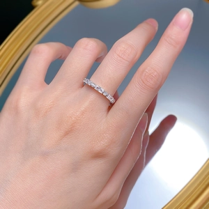 Elegant silver baguette and round cut zircon eternity ring worn on a finger
