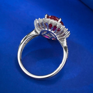 Detailed side view of S925 silver ring with red oval gemstone and floral halo setting