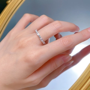 Detail of a silver-toned ring with baguette and round-cut cubic zirconia in a line