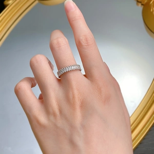 Detail of 925 sterling silver ring with double-row diamonds and beaded edges on finger