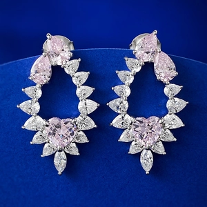 S925 silver drop earrings with pink heart diamond and pear-cut stones on blue velvet
