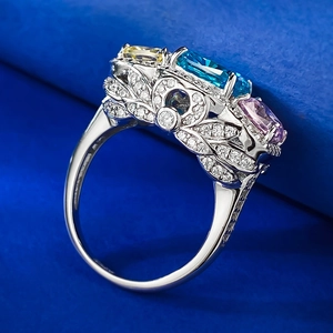 Luxurious silver ring with colorful oval stones and intricate filigree leaf design