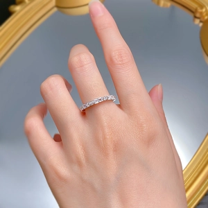 Detailed view of baguette and round cut stones on a polished silver eternity ring band