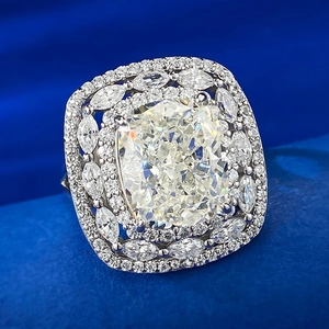 Luxury 5ct cushion cut ring with double halo marquise accents on blue velvet