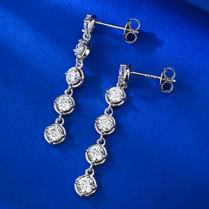 Detailed shot of S925 sterling silver long drop earrings with five claw-set zircons