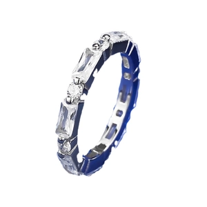 Fashionable ring with baguette-cut and round zircons on blue enamel band at 45-degree angle