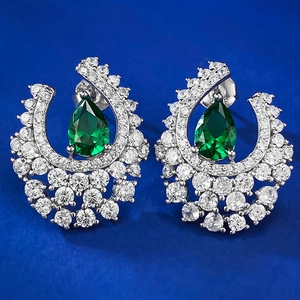S925 silver pear-cut emerald earrings with halo crystal stones on dark background