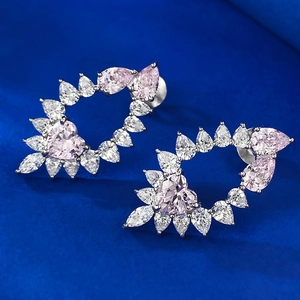 Macro detail of S925 silver heart stud earrings with pink and white cubic zirconia