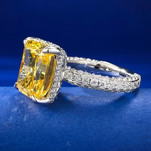 Close-up of a 925 silver ring featuring a large radiant-cut yellow gemstone in pavé setting