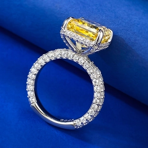 Macro side view of rectangular yellow diamond ring in S925 sterling silver halo setting
