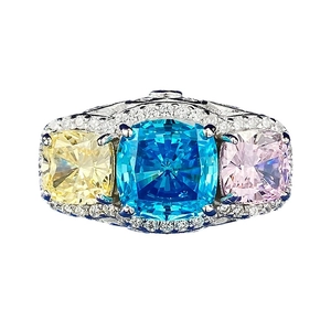 Three-stone cushion cut ring with yellow blue pink crystals in silver setting