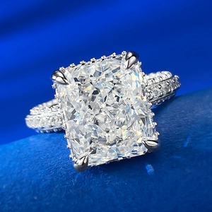 Macro detail of high carbon diamond ring with radiant cut and halo setting on blue velvet
