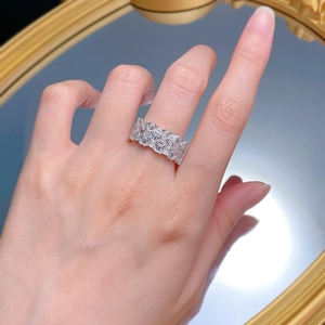 Detailed view of baguette-cut zircon eternity ring with three rows of shimmering stones