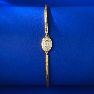 Macro view of golden bohemian cuff bracelet with bark texture and oval zircon center