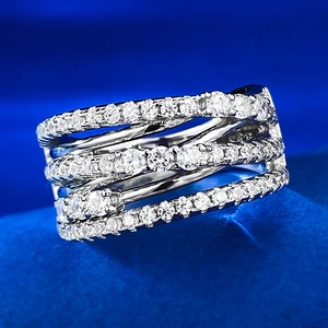 Detailed macro shot of a multi-layer crisscross silver ring with pavé-set round cubic zirconia