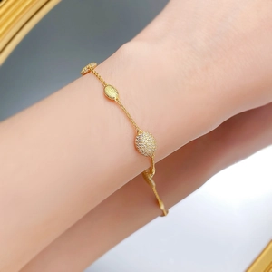Gros plan d'un bracelet bohème doré avec texture brossée et incrustations de zircon