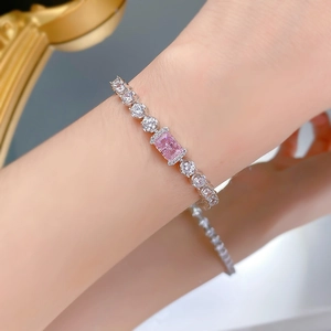 Close-up of S925 silver tennis bracelet with ice-cut pink diamond on woman's wrist