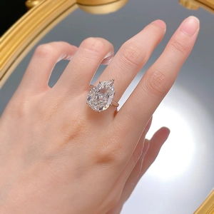 Pear cut carbon diamond engagement ring in 925 sterling silver on woman's hand