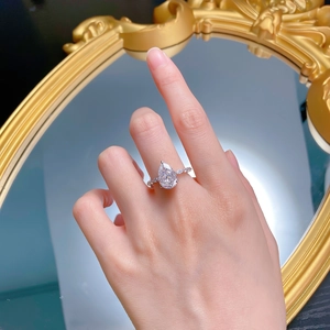 Detailed view of luxury S925 silver pear cut sparkling diamond ring on model hand