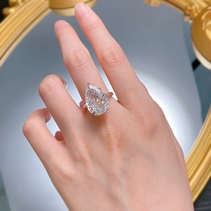 Macro view of pear cut sparkling carbon diamond ring with elegant four-prong setting