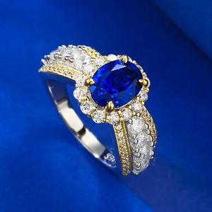 Detail of 925 silver cocktail ring with oval blue sapphire and pavé diamonds