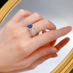 Detail of a 925 silver French lace ring with an oval sapphire and gold plating