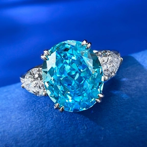 Macro detail of oval sea-blue ice cut gemstone ring with pear-shaped side diamonds