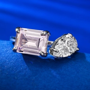 Macro detail of S925 silver ring featuring pink emerald-cut and white teardrop gems