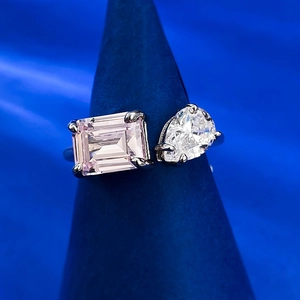 Detail of adjustable silver ring with pear-cut clear and emerald-cut pink gemstones