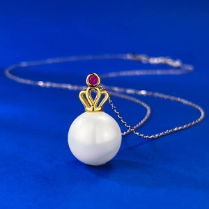 Elegant 11mm white pearl pendant with golden crown and ruby on a silver necklace