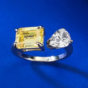 Close-up of S925 silver Toi et Moi ring with emerald-cut yellow and pear-cut white stone