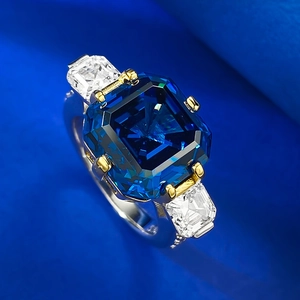 Three-stone S925 silver ring featuring Asscher-cut royal blue sapphire with gold-tone prongs