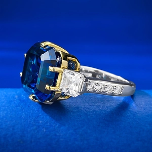 Macro side view of S925 silver ring with Asscher cut blue sapphire and sparkling zircon