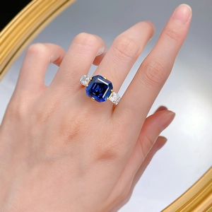 S925 silver ring with Asscher cut royal blue sapphire and baguette side stones on finger