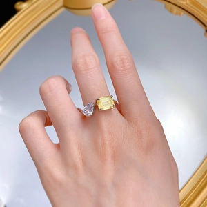 Detail shot of a double stone open ring with yellow emerald cut gem and pear teardrop stone