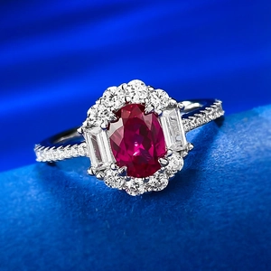 Macro detail of oval sapphire ring with sparkling halo and baguette accents