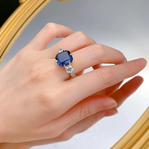 Close-up of royal blue sapphire ring with rectangular cut stones and gold band