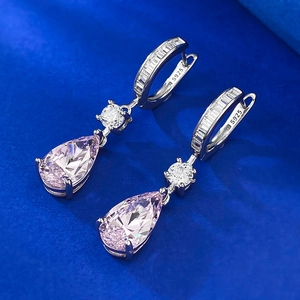 Macro detail of pear-cut pink gems on silver drop earrings with S925 sterling silver stamp