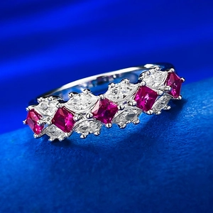 Macro detail of S925 silver ring featuring alternating red and white gemstones