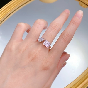 Detailed shot of S925 silver open ring with pear-cut white and emerald-cut pink stones